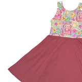 Children's dress with a colorful floral top and maroon skirt on a white background